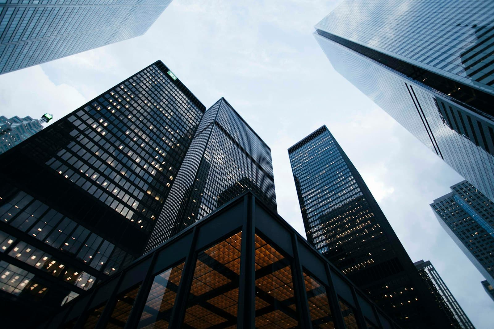 Skyscrapers photographed from street level against a pale sky. Names on a skyline have to stay readable from far away, as a product name must in a short title.